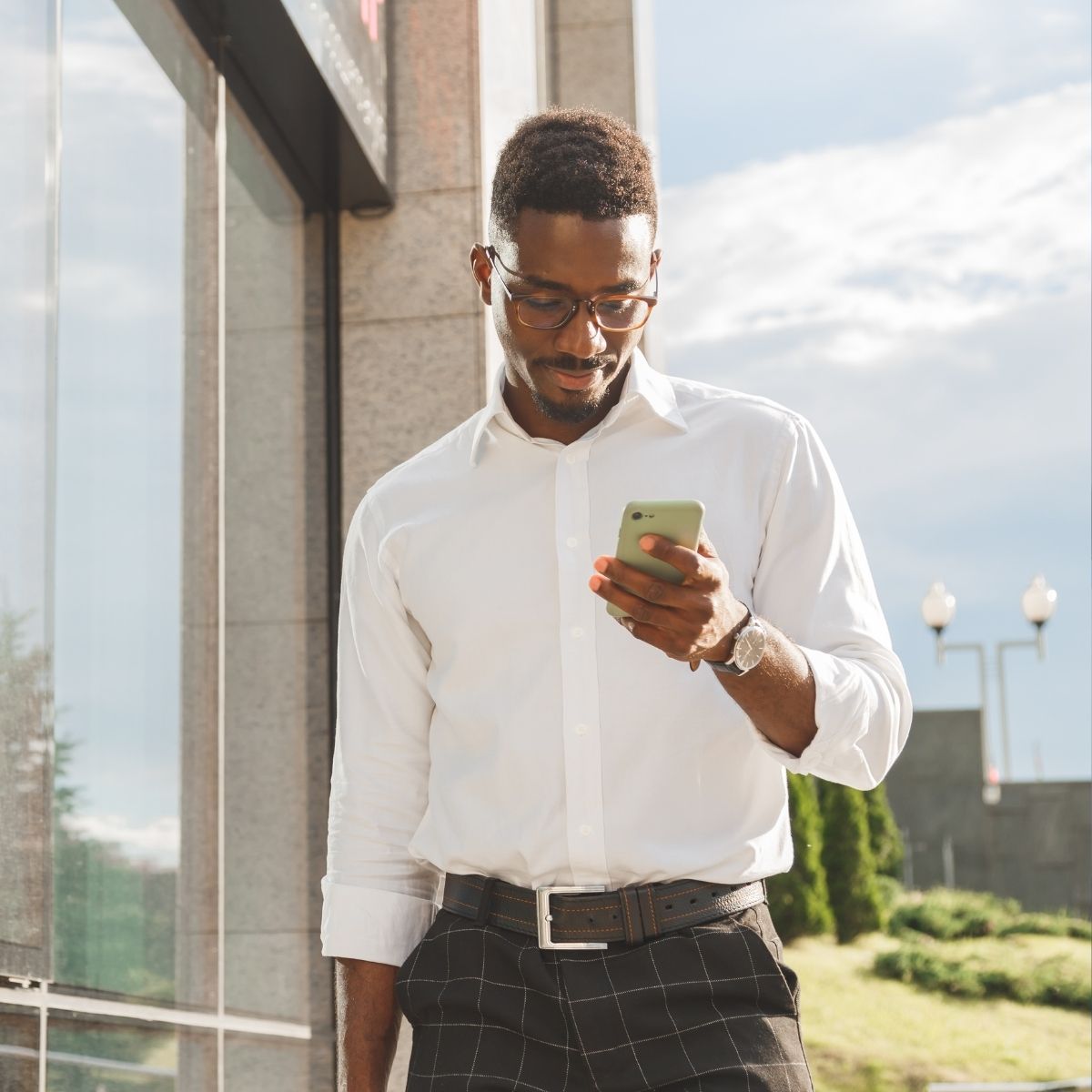 Agent de sécurité privé debout avec smartphone.